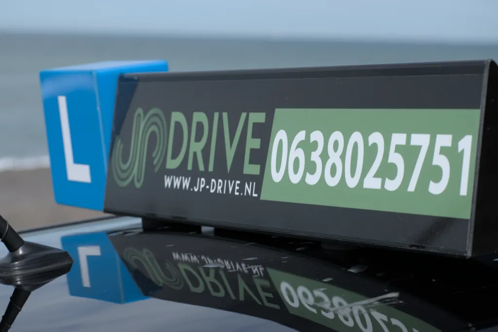 Person sitting in the driver's seat of a Jeep, opening the sunroof with one hand while holding the steering wheel with the other.